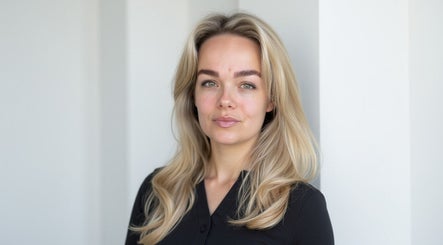 Elegant woman with blonde hair in black attire at SMP Aesthetics Kent, Royal Tunbridge Wells, England, GB.