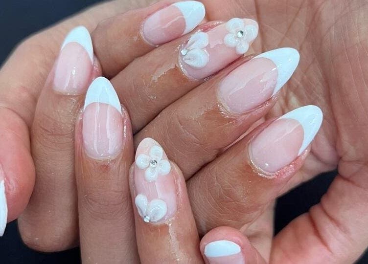 Elegant floral nail art at Kaybee Nails, Cape Town, Western Cape, ZA, featuring delicate white flowers.