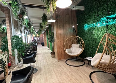 Espacio acogedor en Hair Therapy Barcelona por Ana Nascimento, Barcelona, Catalunya, ES, con sillas modernas y plantas colgantes.