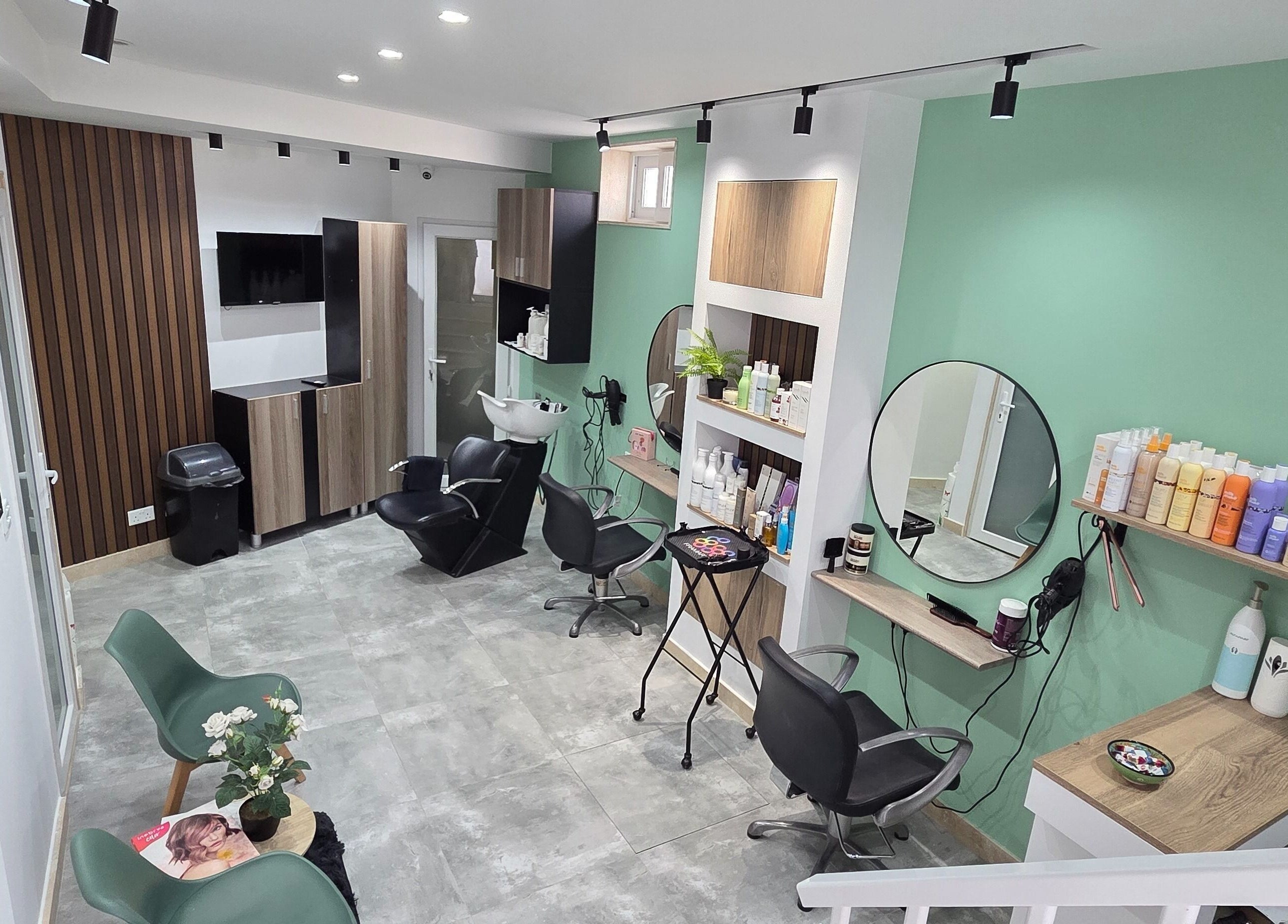 VV Hair Studio in Ħ'attard, MT, features modern salon chairs and styling stations in a serene setting.