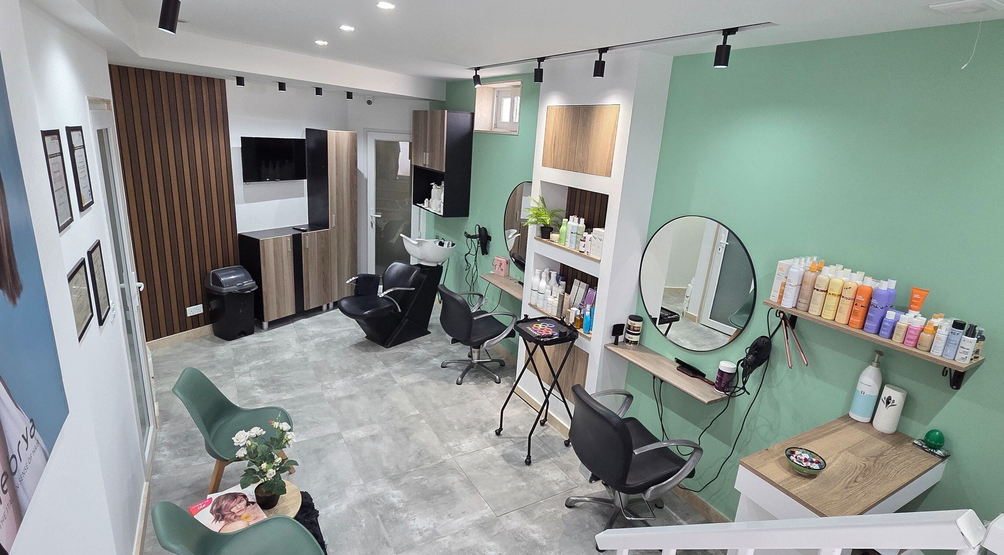 VV Hair Studio in Ħ'attard, MT, features modern salon chairs and styling stations in a serene setting.