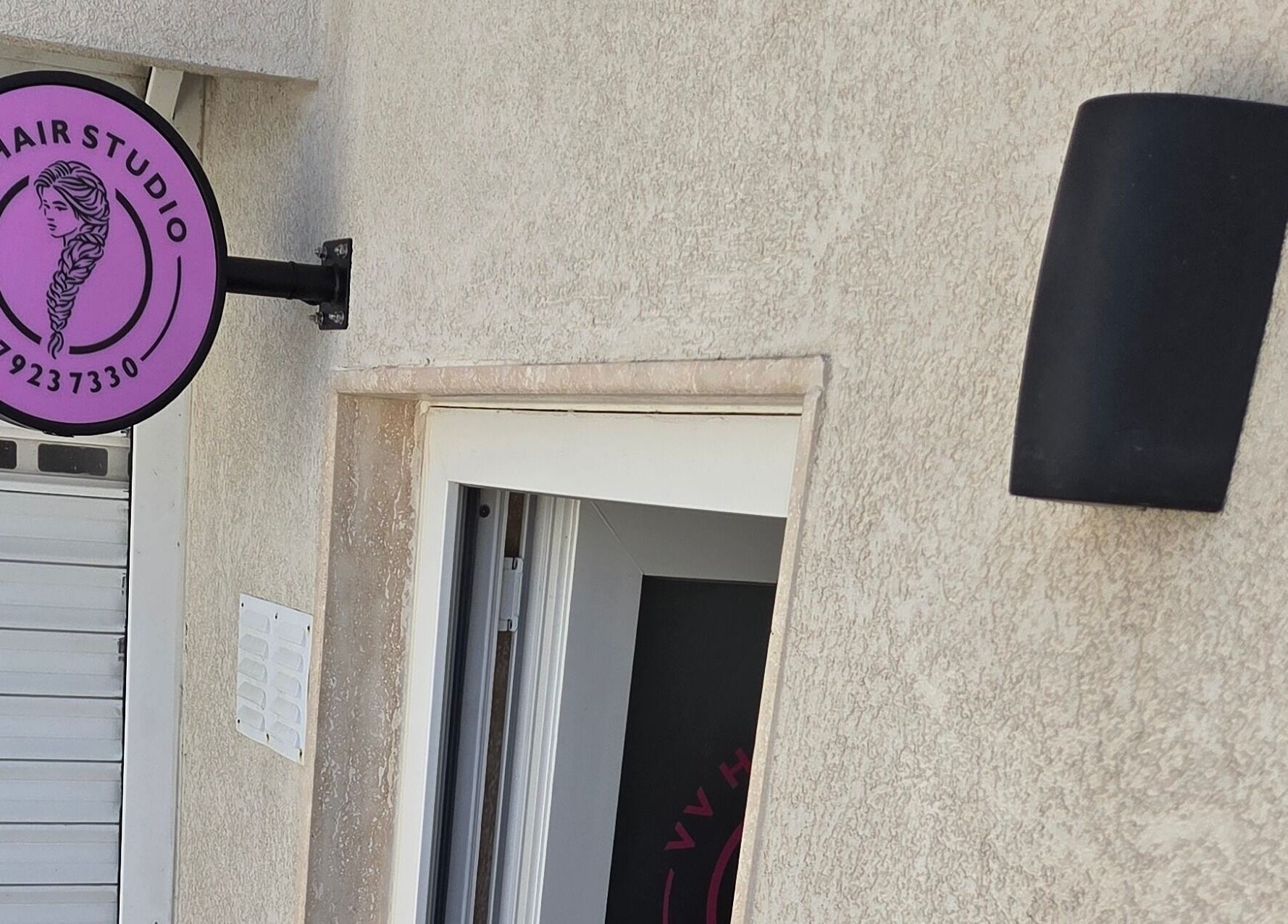 VV Hair Studio entrance with vibrant purple sign in Ħ'attard, MT.