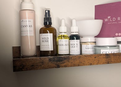 Natural skincare products on a wooden shelf at I J Beauty By Lauren, St Helens, England, GB.
