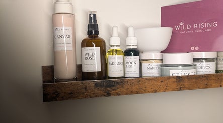 Natural skincare products on a wooden shelf at I J Beauty By Lauren, St Helens, England, GB.