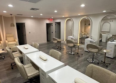 Chic interior of Linduk by Lizzy in Cape Coral, Florida, US featuring modern salon chairs and stations.