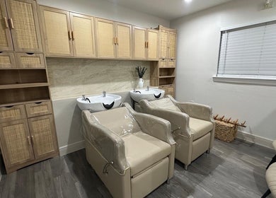 Cozy hair washing area at Linduk by Lizzy, Cape Coral, Florida, US featuring plush chairs and sleek sinks.