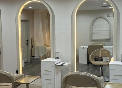 Chic salon setup at Linduk by Lizzy with modern chairs and mirrors in Cape Coral, Florida, US.