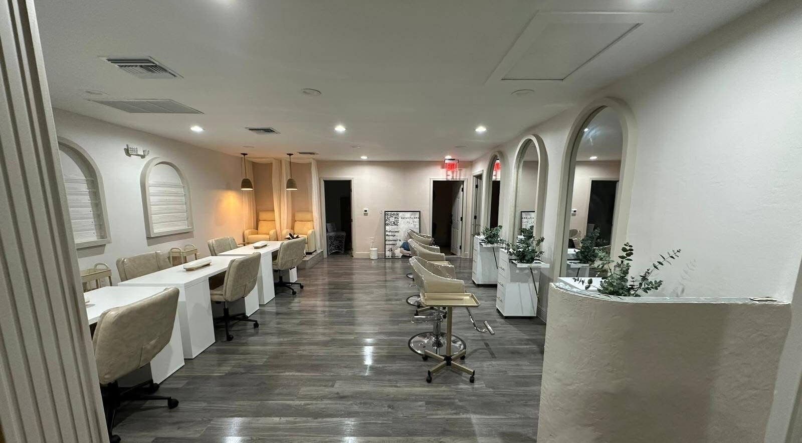 Elegant beauty salon at Lizzy, Cape Coral, Florida, US, featuring luxurious seating and modern decor.
