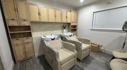 Elegant salon wash area at Lizzy in Cape Coral, Florida with modern chairs and cabinetry.