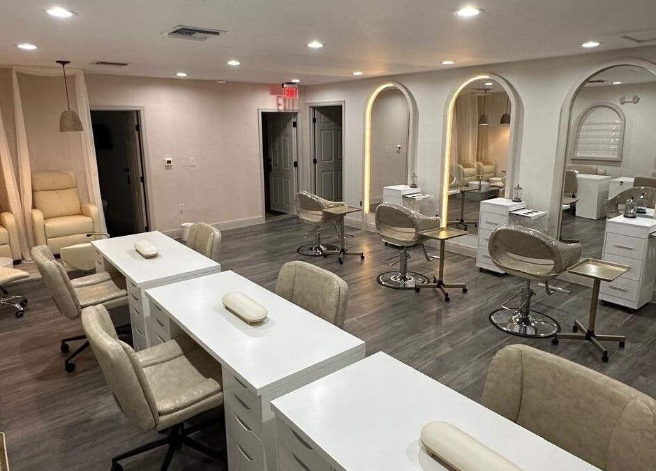 Spacious and modern beauty salon interior at Lizzy in Cape Coral, Florida, US, with stylish mirrors and seating.