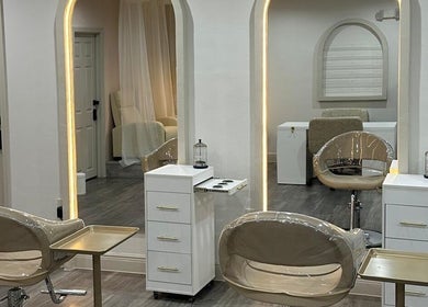 Chic beauty stations at Lizzy in Cape Coral, Florida, US with modern chairs and sleek decor.