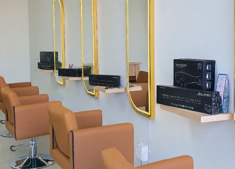 Sleek salon chairs and golden mirrors at Luxe Hair Salon & Extensions Supplier, Cape Town, Western Cape, ZA.