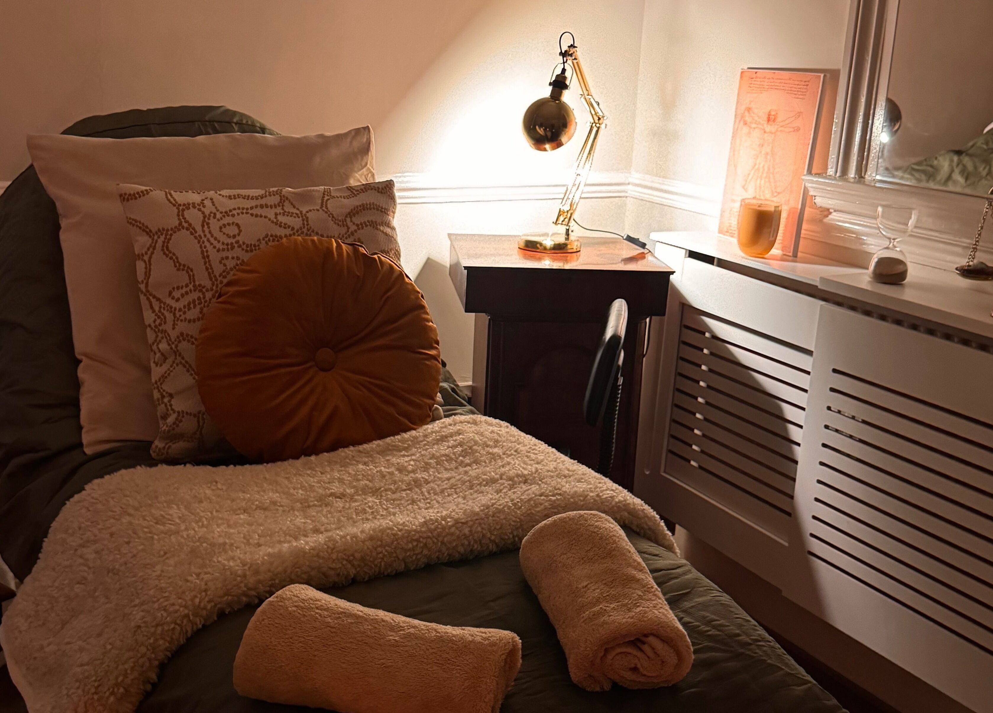Relaxation room at Soul Sister Holistic Therapy & Wellbeing, Neath, Wales, GB with plush towels and soft lighting.