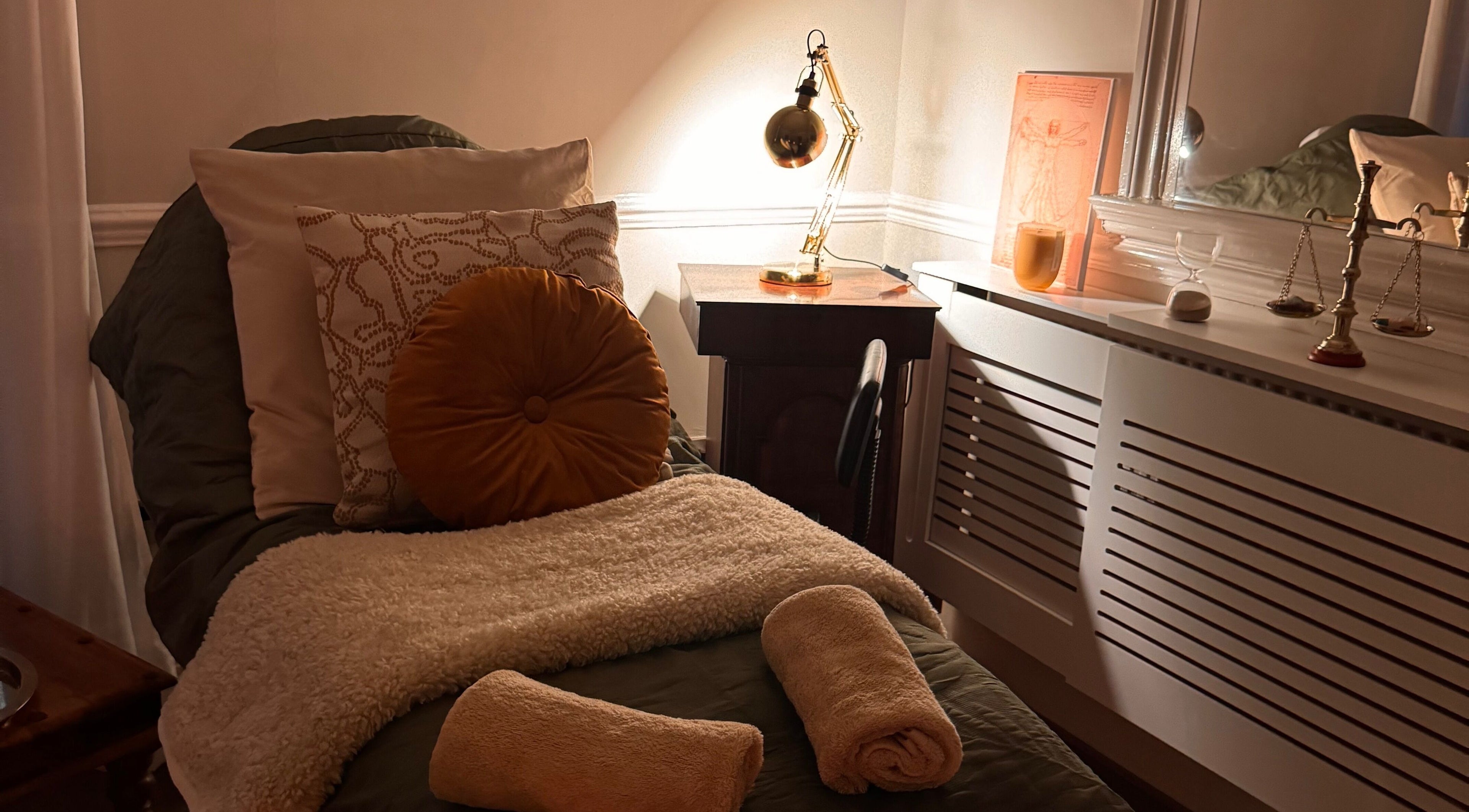 Relaxation room at Soul Sister Holistic Therapy & Wellbeing, Neath, Wales, GB with plush towels and soft lighting.