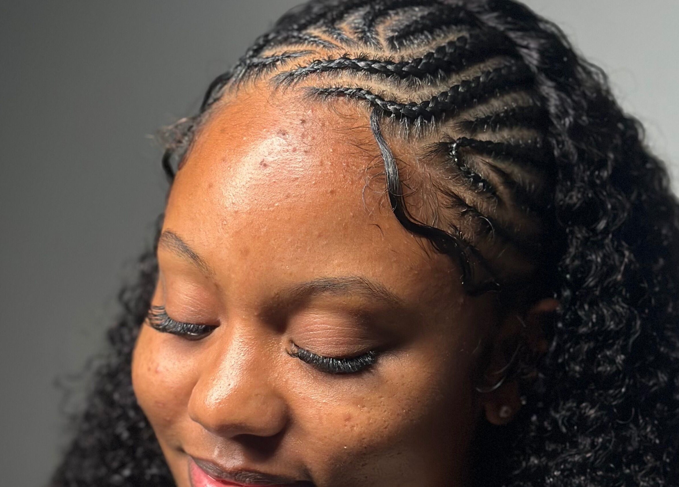Close-up of intricate cornrow braids at The Lash Lounge, Kingston, St. Andrew Parish, JM.