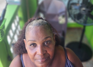 Client enjoying serene atmosphere at T'Hairapy Beauty Studio, Christ Church, BB with stylish setting.