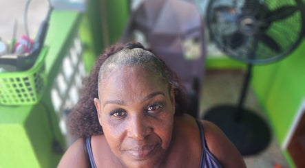 Client enjoying serene atmosphere at T'Hairapy Beauty Studio, Christ Church, BB with stylish setting.