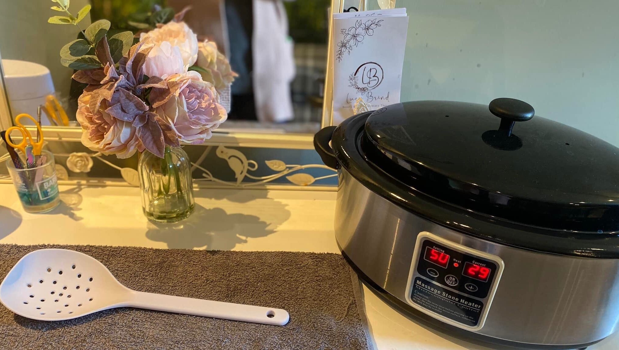 Massage heater and flowers at Lucy Brind Beauty and Complementary Therapy, Cirencester, England, GB.