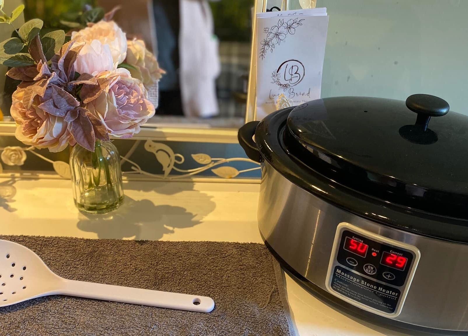 Massage heater and flowers at Lucy Brind Beauty and Complementary Therapy, Cirencester, England, GB.