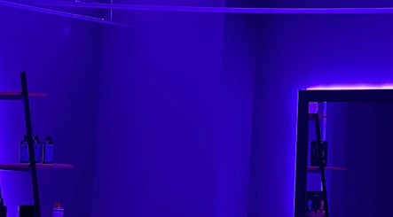 Stylish interior at Barbershop 24K Cutz in Stara Zagora, BG, featuring modern purple lighting.