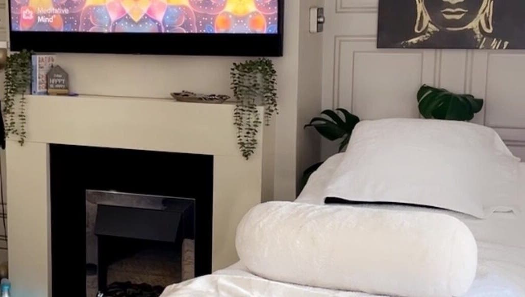 Relaxing spa room at Touched by Divinity, Heolgerrig, Wales, GB with a cozy bed and calming decor.