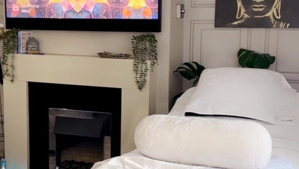 Relaxing spa room at Touched by Divinity, Heolgerrig, Wales, GB with a cozy bed and calming decor.