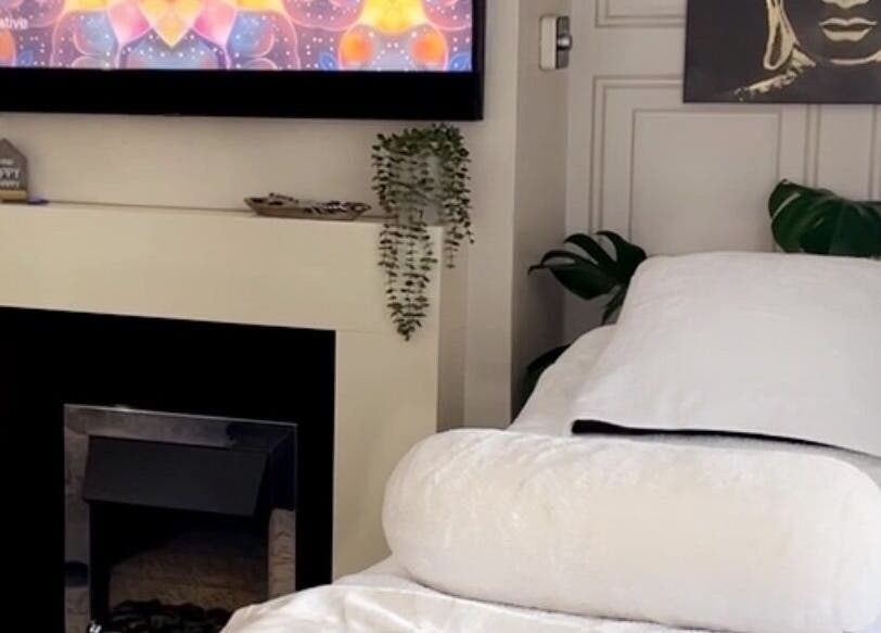 Relaxing spa room at Touched by Divinity, Heolgerrig, Wales, GB with a cozy bed and calming decor.