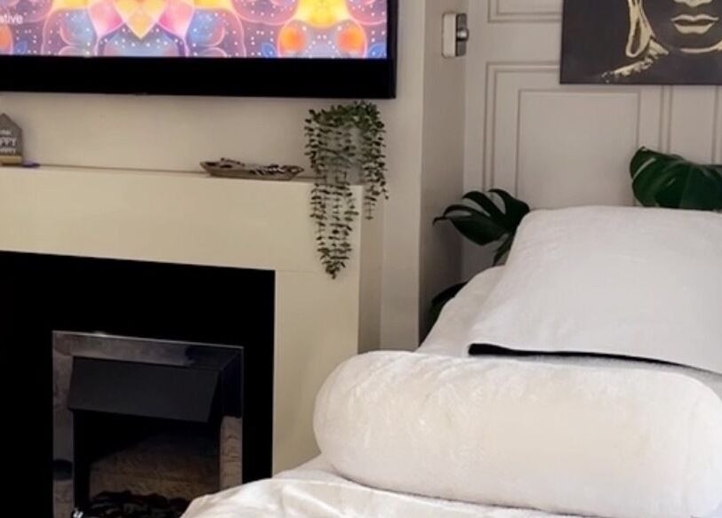 Relaxing spa room at Touched by Divinity, Heolgerrig, Wales, GB with a cozy bed and calming decor.