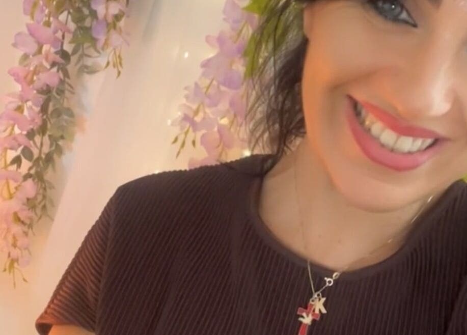 Smiling individual with floral backdrop, Touched by Divinity, Heolgerrig, Wales, GB.