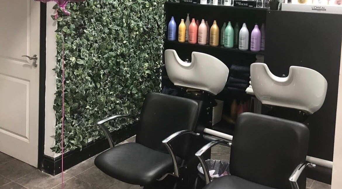 Stylish salon chairs and wash station at KC Phibrows & Beauty, Dublin, County Dublin, IE with lush greenery decor.