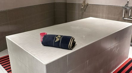 Luxurious spa room at KUPA CARELINE SALON, Arad, Muḥāfaẓat Al-muḥarraq, BH featuring a massage table and relaxing decor.
