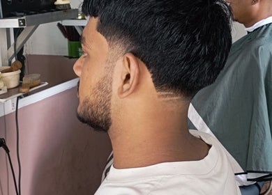Client at Barber shop in Yangon, Yangon Region, MM with a fresh haircut and styled side part.