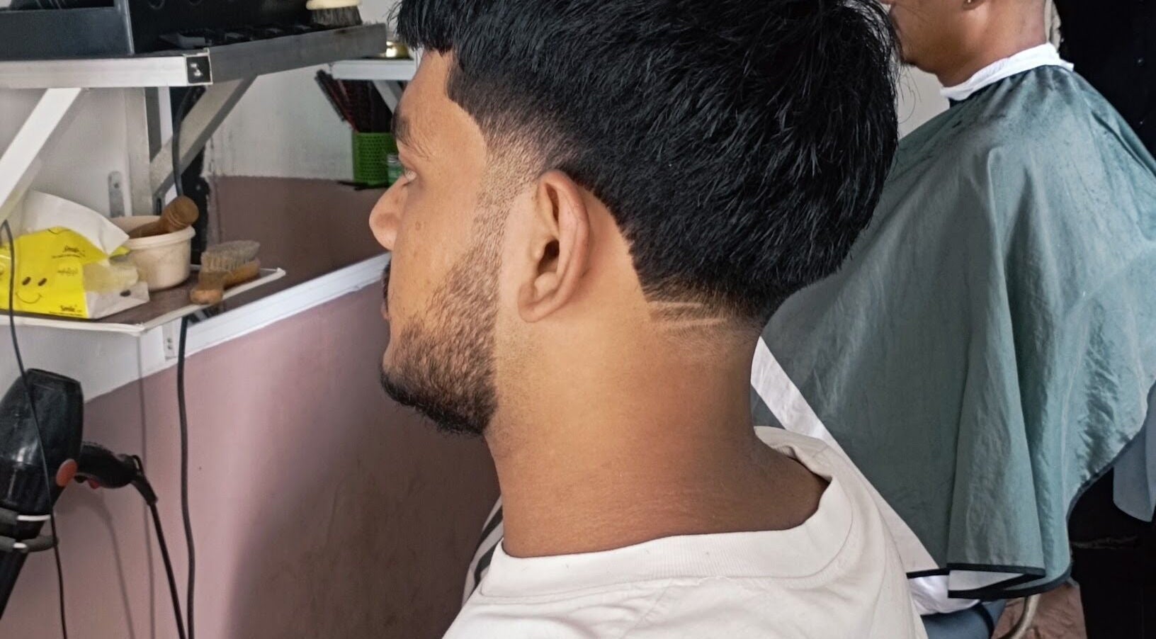 Client at Barber shop in Yangon, Yangon Region, MM with a fresh haircut and styled side part.