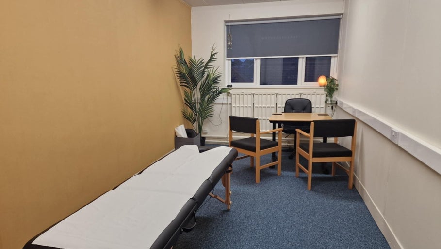 Comfortable therapy room at Revive Sports Therapy And Massage, York, England, GB, featuring a massage table and seating.
