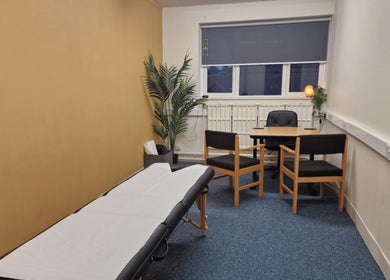 Comfortable therapy room at Revive Sports Therapy And Massage, York, England, GB, featuring a massage table and seating.