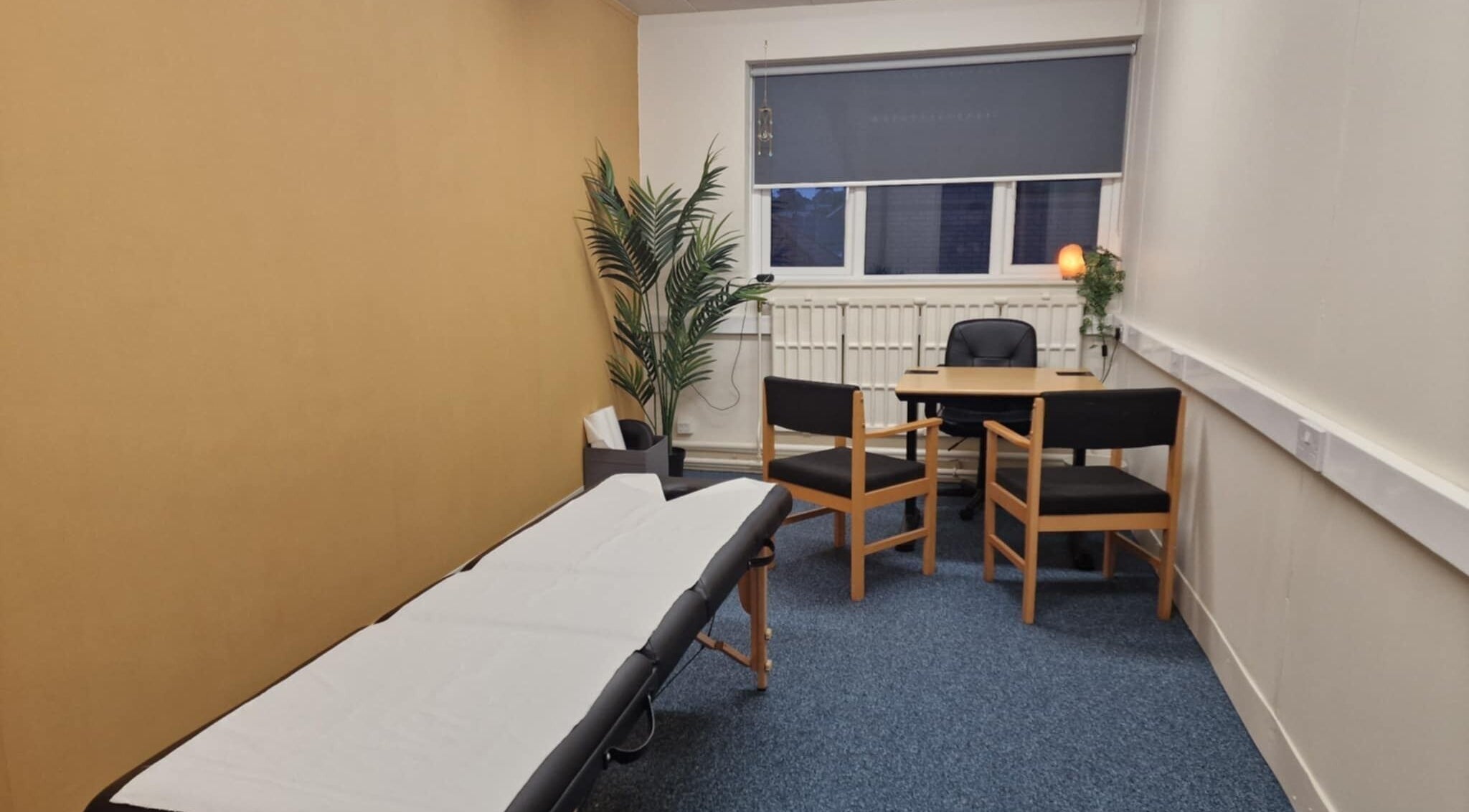 Comfortable therapy room at Revive Sports Therapy And Massage, York, England, GB, featuring a massage table and seating.