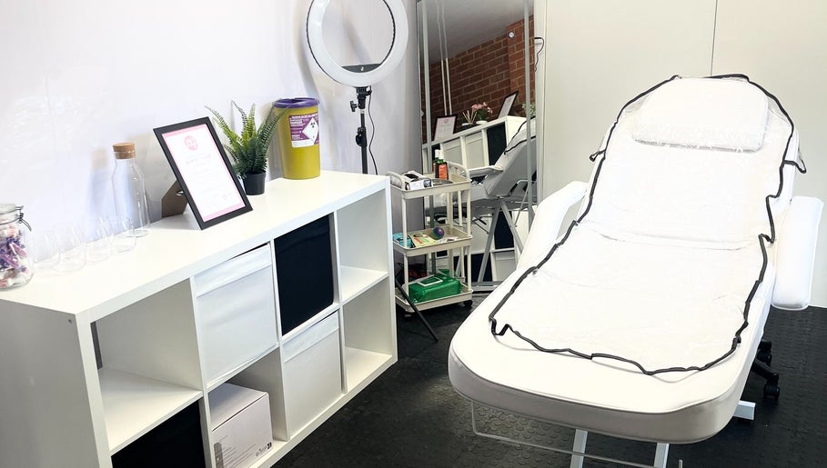 Cozy treatment room at AW House Of Aesthetics, Wick, England, GB. Features a comfortable chair and elegant decor.