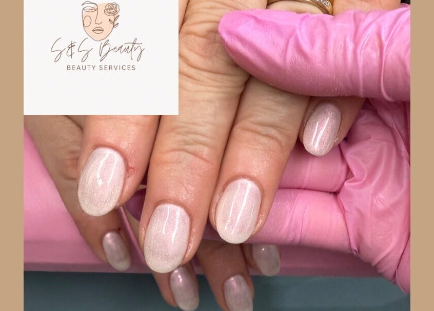 Close-up of manicured hands showcasing glossy finish by S&S Beauty Services in Madeley, England, GB.