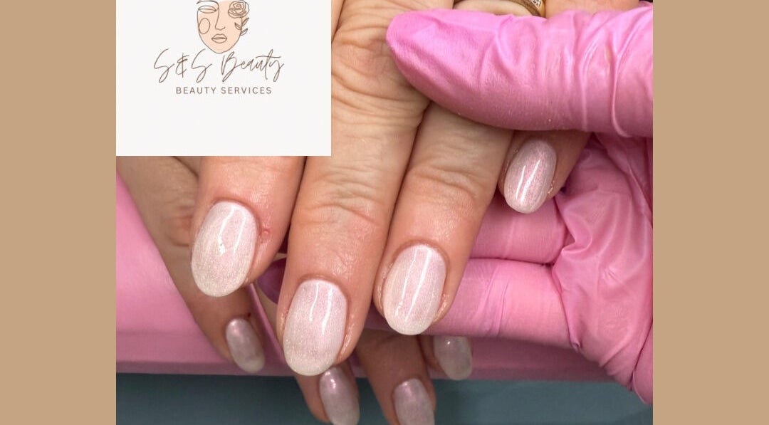 Close-up of manicured hands showcasing glossy finish by S&S Beauty Services in Madeley, England, GB.