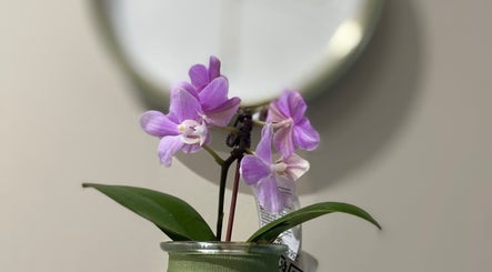 Purple orchids in a vase at Lemaître, Sandton, Gauteng, ZA, add elegance to the serene venue atmosphere.