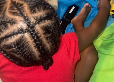 Intricate braids styled at Kurasao Hair, Willemstad, Curaçao, CW enhancing a child's look.