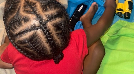 Intricate braids styled at Kurasao Hair, Willemstad, Curaçao, CW enhancing a child's look.