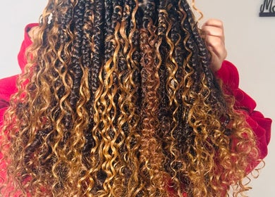 Golden brown curly hairstyle showcased at Millyk Beauty, Burlington, Massachusetts, US.