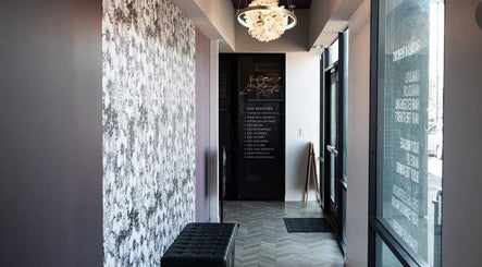 Elegant entryway of Marmac Studio, Chula Vista, California, US, featuring floral walls and a chandelier.