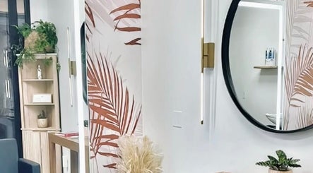 Modern interior of Marmac Studio, Chula Vista, California, US with round mirror and tropical decor.