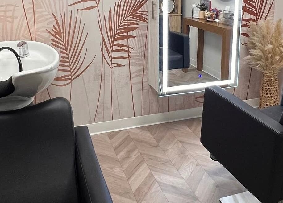 Chic interior of Marmac Studio in Chula Vista, California, US featuring a salon chair and vibrant wall decor.