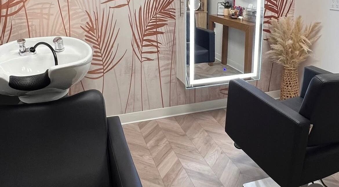 Chic interior of Marmac Studio in Chula Vista, California, US featuring a salon chair and vibrant wall decor.