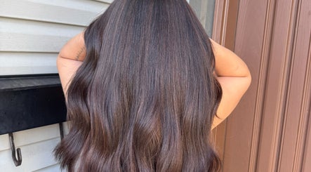 Luxurious long brunette hair styled at Simschair, Surrey, British Columbia, CA, showcasing expert treatment.