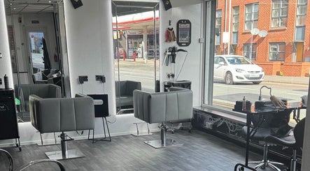 Modern salon interior at Divine Aesthetics & Beauty in Crewe, England, GB, showcasing sleek styling chairs and mirrors.