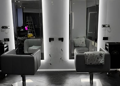 Modern salon interior at Divine Aesthetics & Beauty, Crewe, England, GB with sleek design and styling chairs.